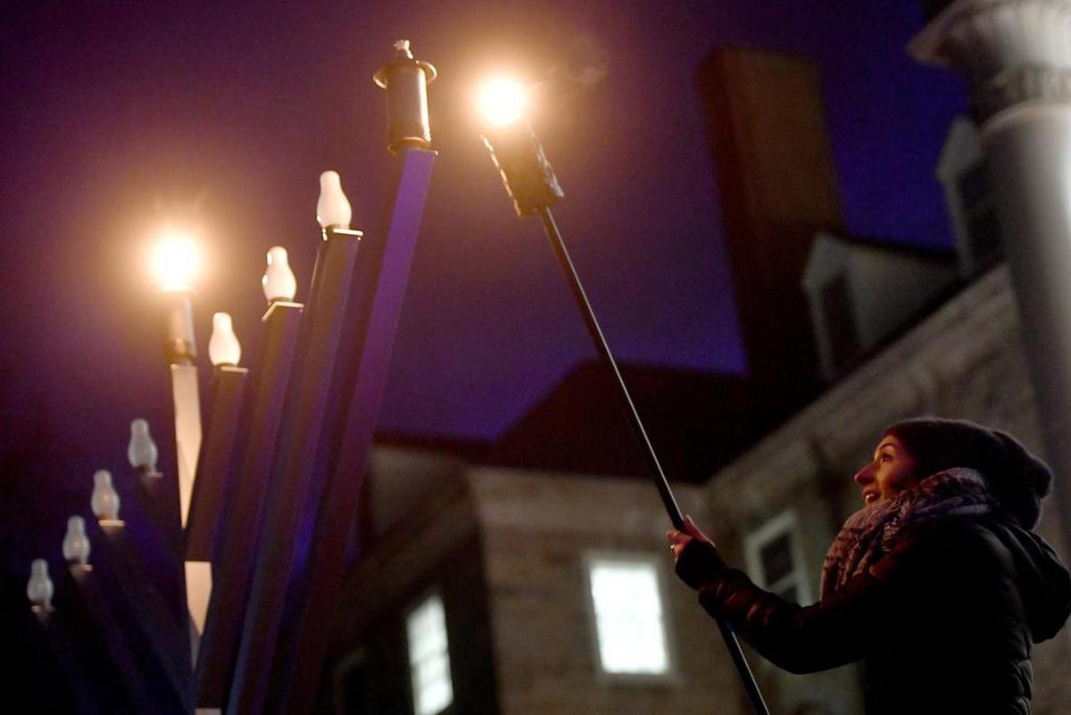 Charlotte Schreiber lights the menorah for the first night of Hanukkah celebration outside of Old Main in 2017.