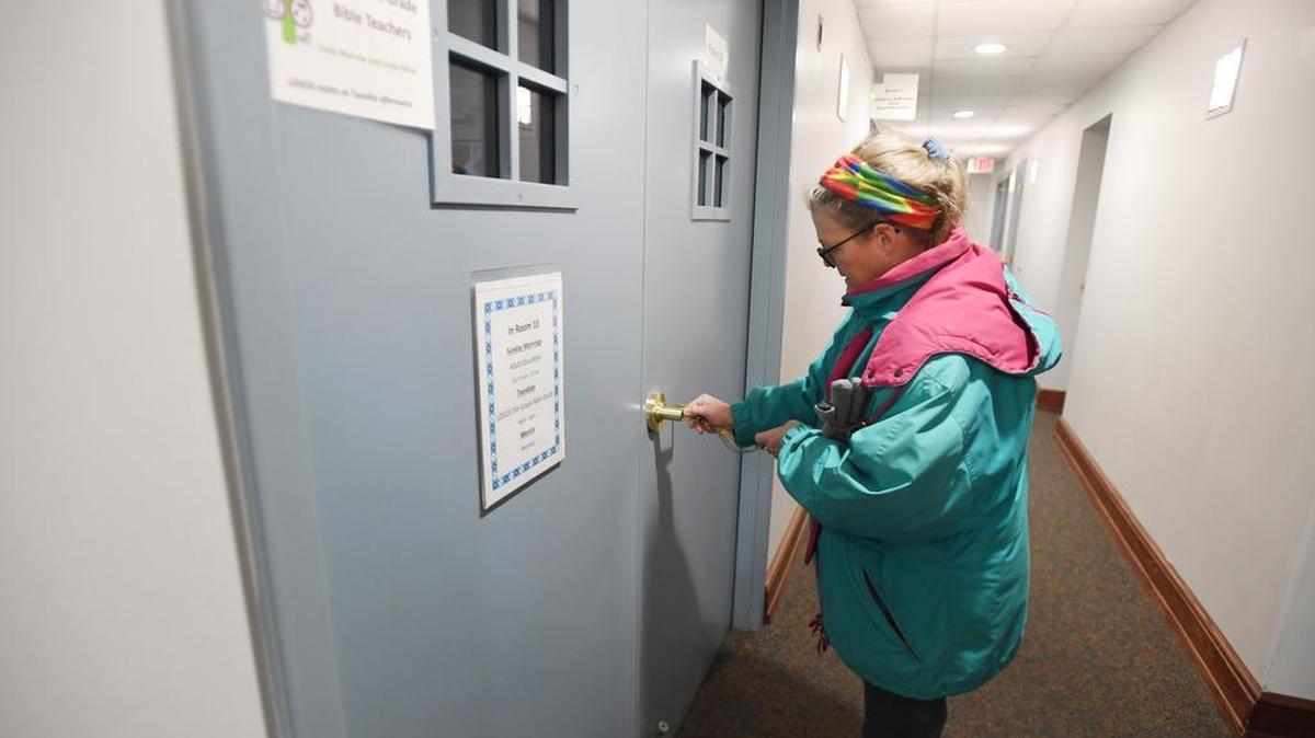 Out of the Cold: Centre County assistant site manager Katie Nurmi opens the door on Saturday to the room where the men’s overnight cots are located at State College Presbyterian Church.