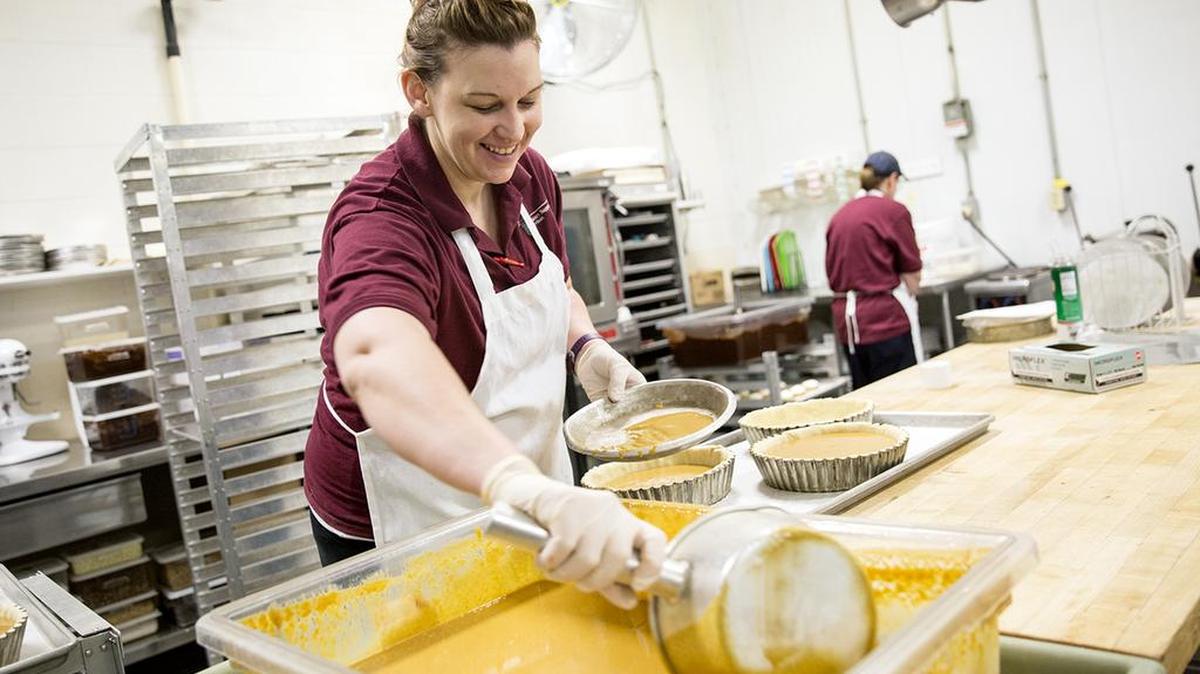 Jessica DeHaas, a bakery assistant at the Penn State Bakery, prepares pumpkin pies for the Nittany Lion Inn on Friday.