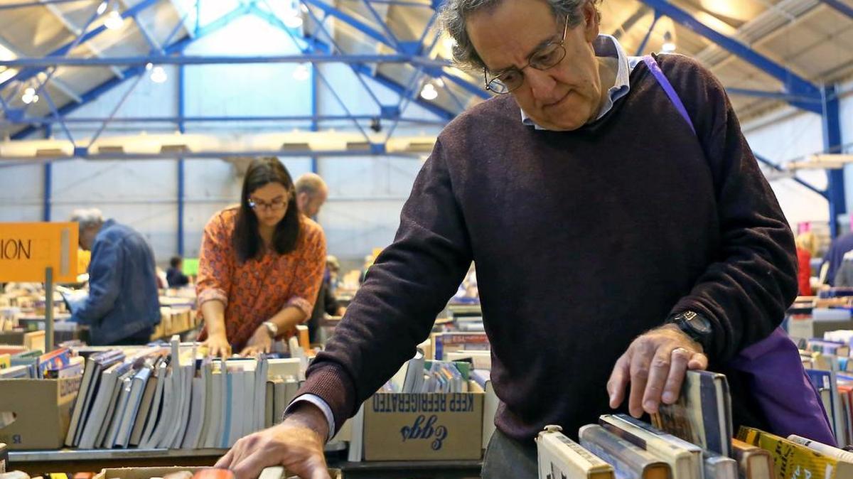 Barry Ruback, of State College, browses through the history section of the 55th annual American Association of University Women book sale held at Penn State’s Snider Agriculture Arena on Sunday.