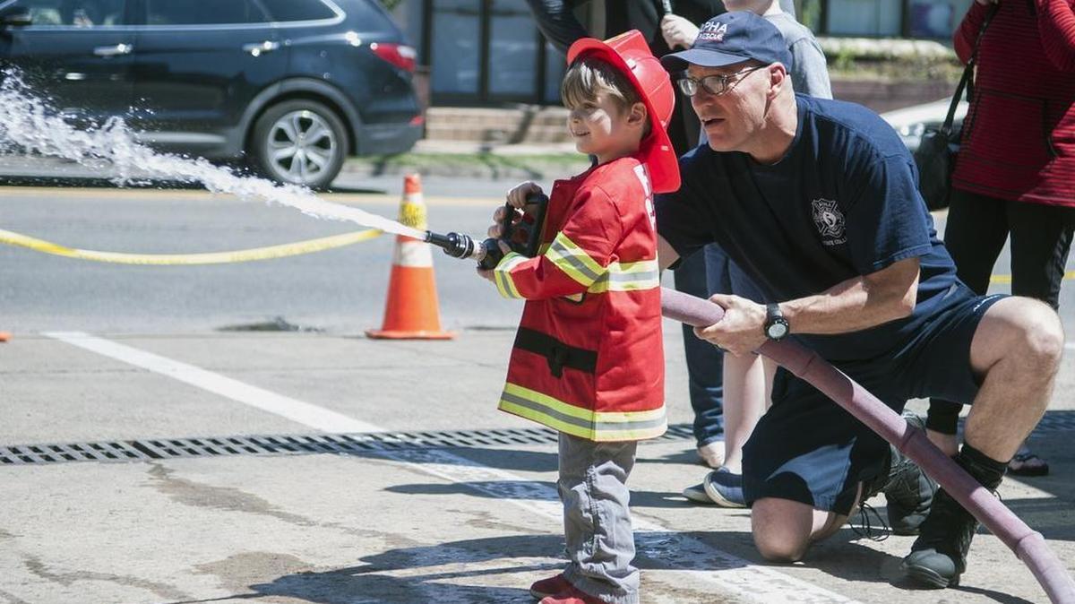 Warren Zettlemoyer, 3, learns how to use a fire hose at the Alpha Fire Company on Sunday in State College.
