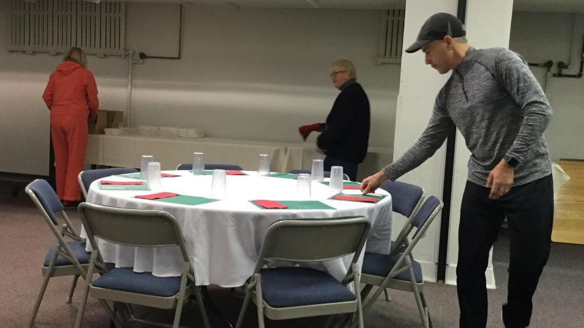 Rick Spangler places silverware in preparation for the Christmas Day dinner at the State College Presbyterian Church.