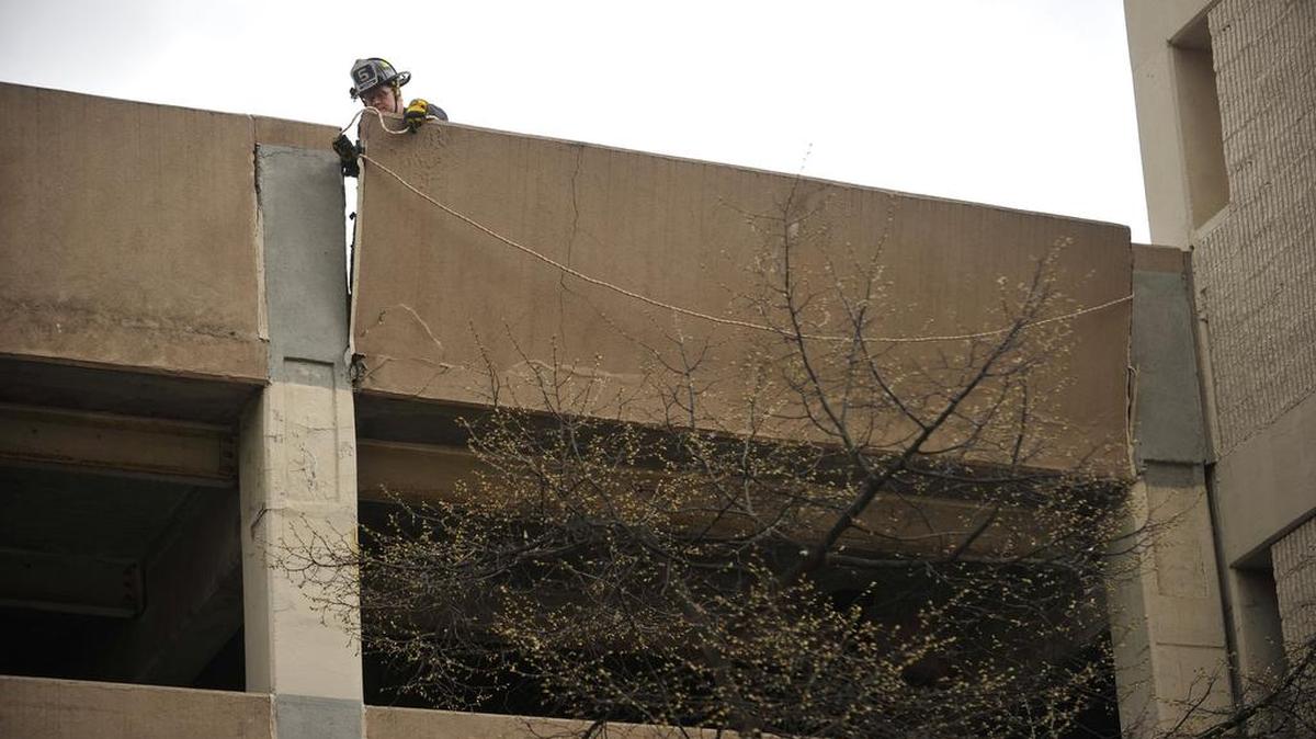 A firefighter works to secure a part of the Pugh Street Garage in April that was knocked loose. The State College Borough Council will vote Monday on several capital improvement projects, including renovations to downtown parking garages.