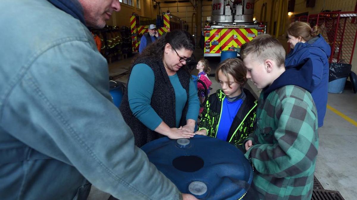 From left, Tom Butler, Deb Nardone, Jonah Little and Richie Butler make a rain barrel on Sunday during a ClearWater Conservancy workshop at Alpha Firehouse 2.