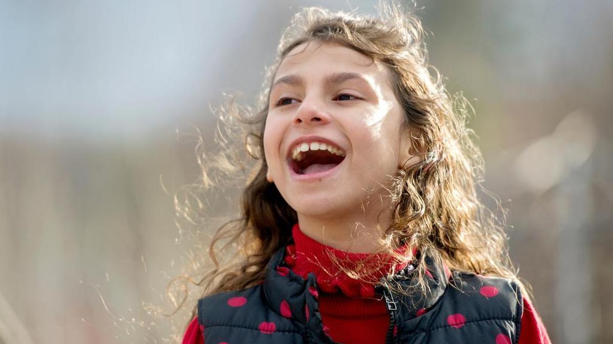 Amina Mannaa, 7, tells an elaborate story about “Alvin and The Chipmunks” as she spends some time with her family at The Arboretum at Penn State on Dec. 19.