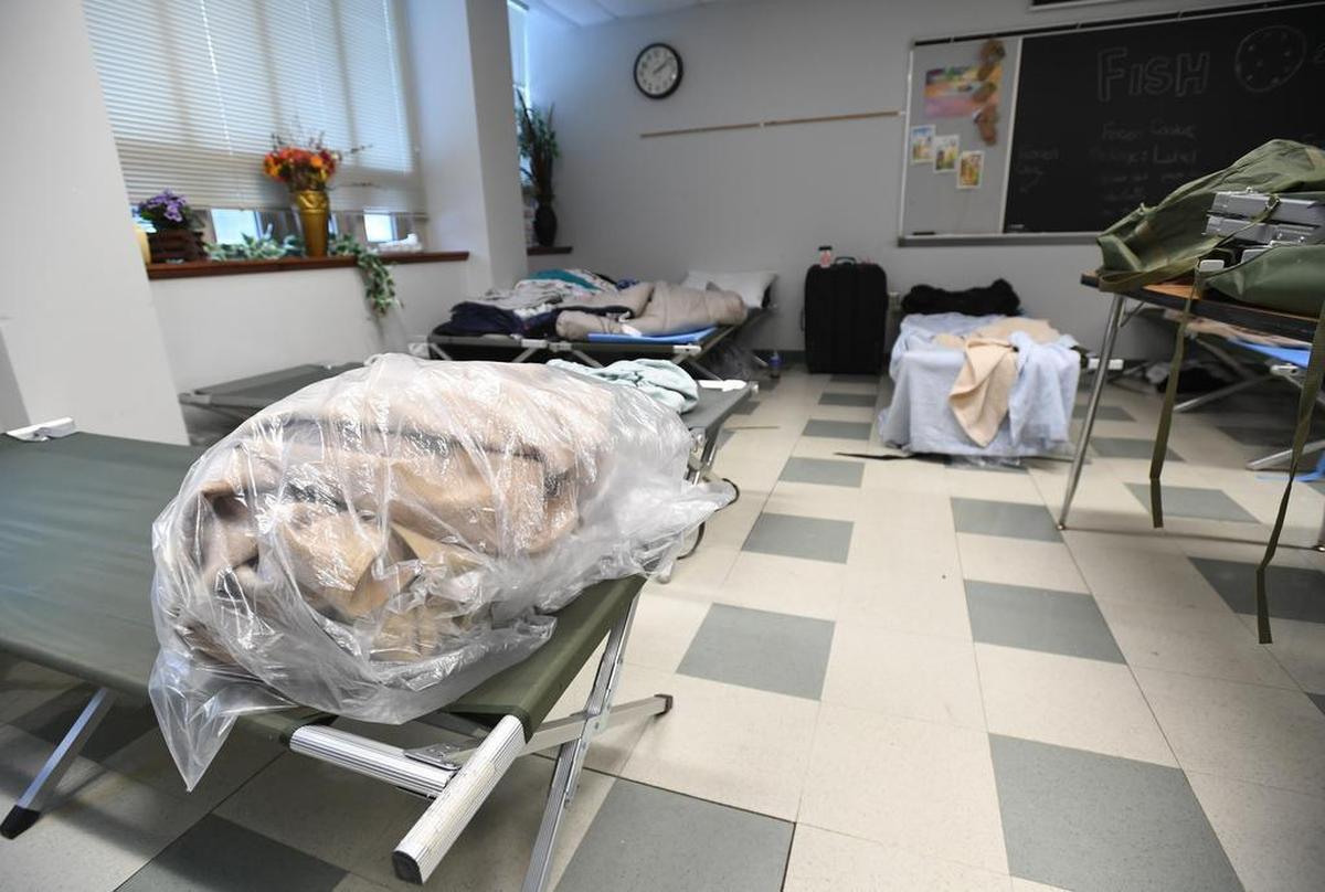 Blankets are folded on top of cots, which are provided by the Out of the Cold: Centre County program, at State College Presbyterian Church in December 2017.
