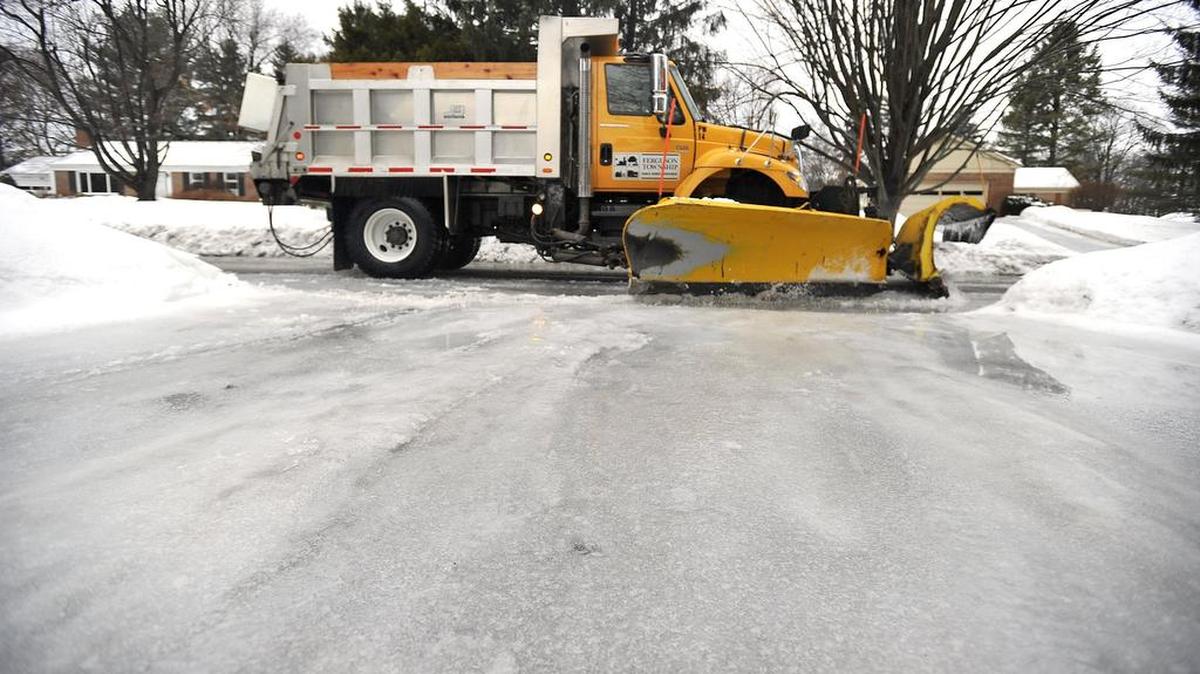 A Ferguson Township truck plows snow off an ice covered road in the Park Hills neighborhood after a storm in March 2015.