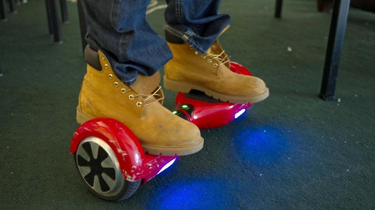 Penn State student Dylan Kim rides his hoverboard in his apartment on Monday, February 22, 2016.