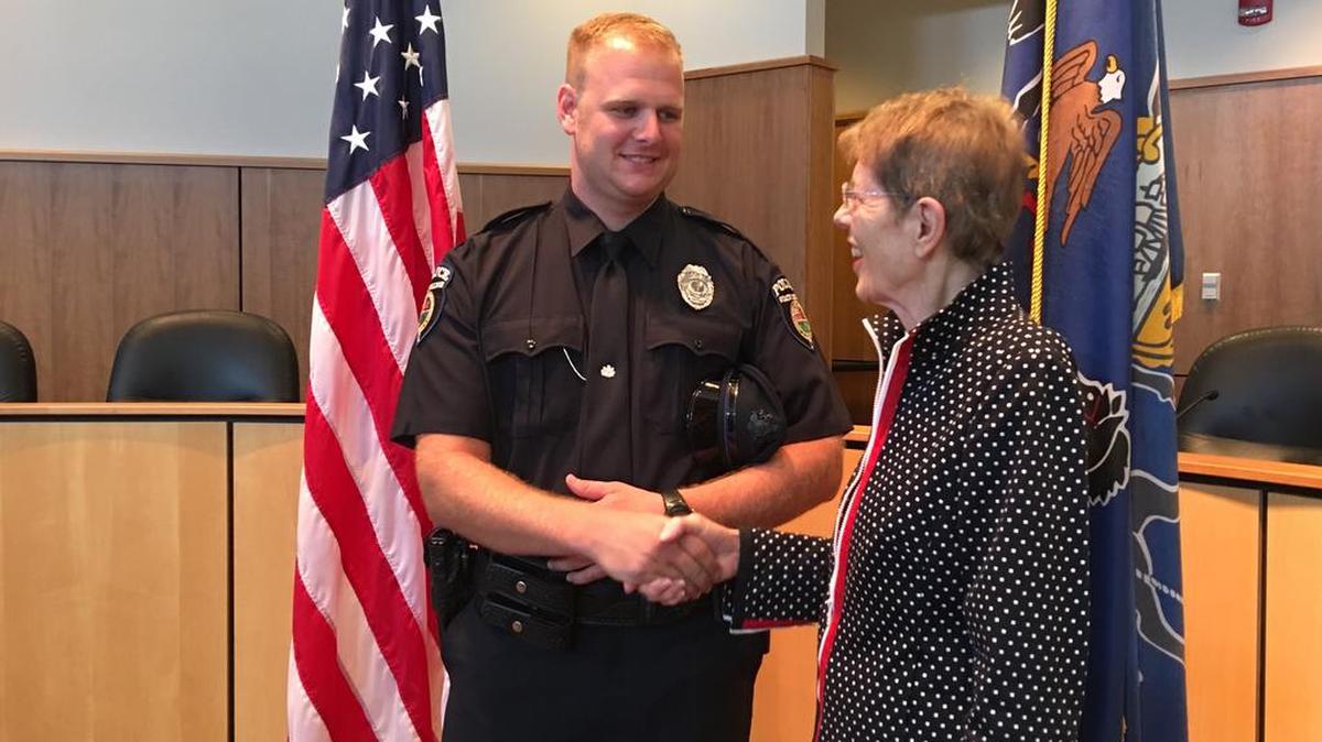 Newly appointed State College police Officer Kevin Orndorff, 26, shakes hands with State College Mayor Elizabeth Goreham after his swearing-in ceremony Tuesday at the State College Municipal Building.