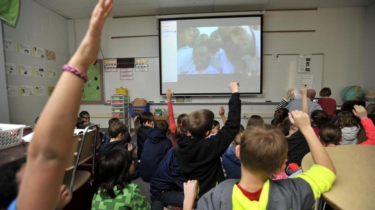 Students raise their hands to ask questions with the Kenyan students. Fourth-grade students in Rich Schmidt’s class at Corl Street Elementary school Skyped with a class in Kenya March 18, 2016.