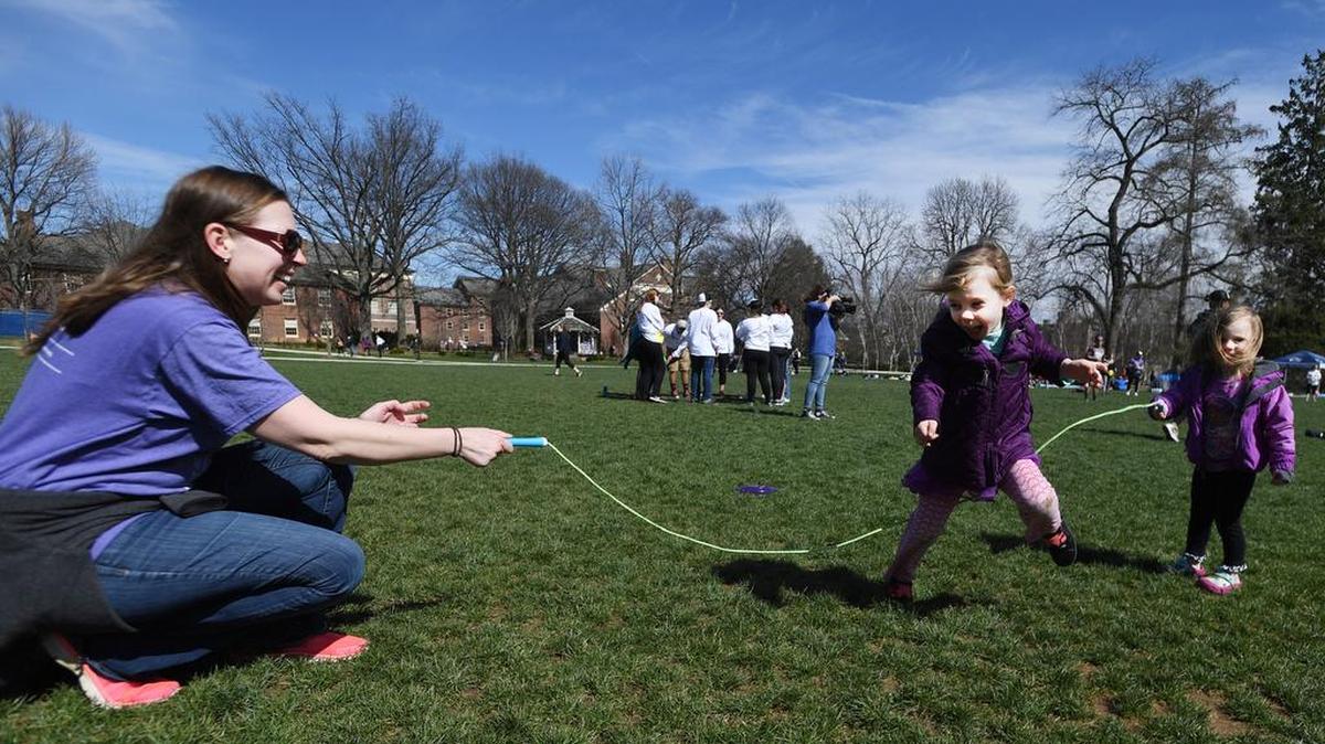 Cancer survivor Elizabeth Hughes plays jumprope with her daughters, Josephine, 4, and Aurelia, 2, during Relay for Life of Penn State on Saturday outside of the HUB-Robeson Center.