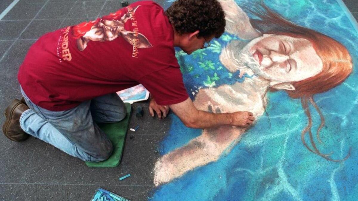 Featured artist Graham Curtis, of Petersburg, works on a sidewalk painting in 2001. In 1999, street painting came to State College in the form of the Downtown State College Italian Street Painting Festival, part of the Central Pennsylvania Festival of the Arts. Curtis is still a featured painter.