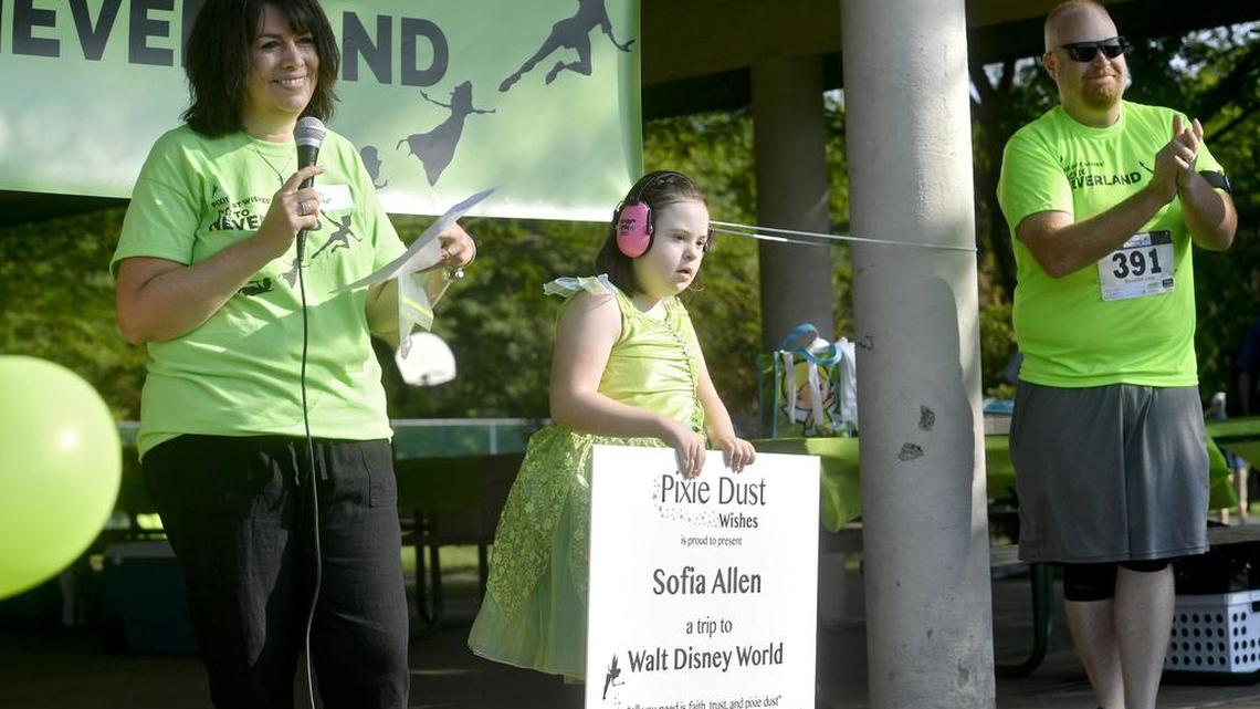 Jaimie Miller, of Pixie Dust Wishes, and her daughter Emma announce the first recipient of a trip to Walt Disney World to Sofia Allen before the Race to Neverland on Saturday, August 19, 2017 at Tom Tudek Memorial Park.