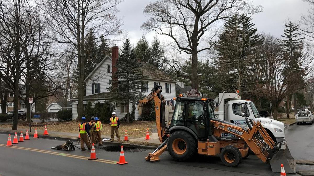 A crew makes repairs to a broken water main on East Park Avenue on Thursday.