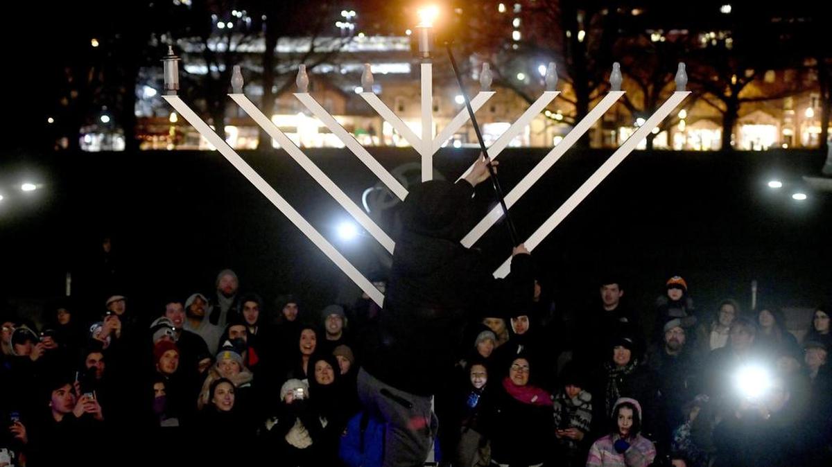 Jake Wolf lights the shamash for the first night of Hanukkah celebration outside of Old Main in 2017.