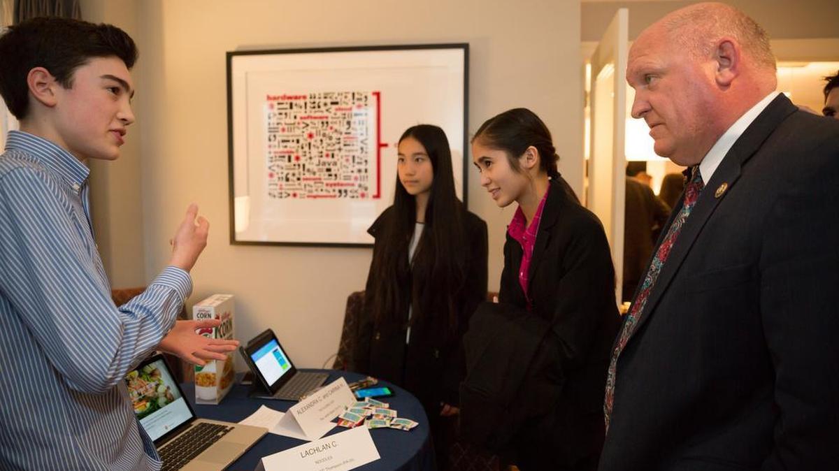 Lachlan Campbell shares his app, Noodles, with Rep. Glenn Thompson, R-Howard Township, during the House of Code 2016.