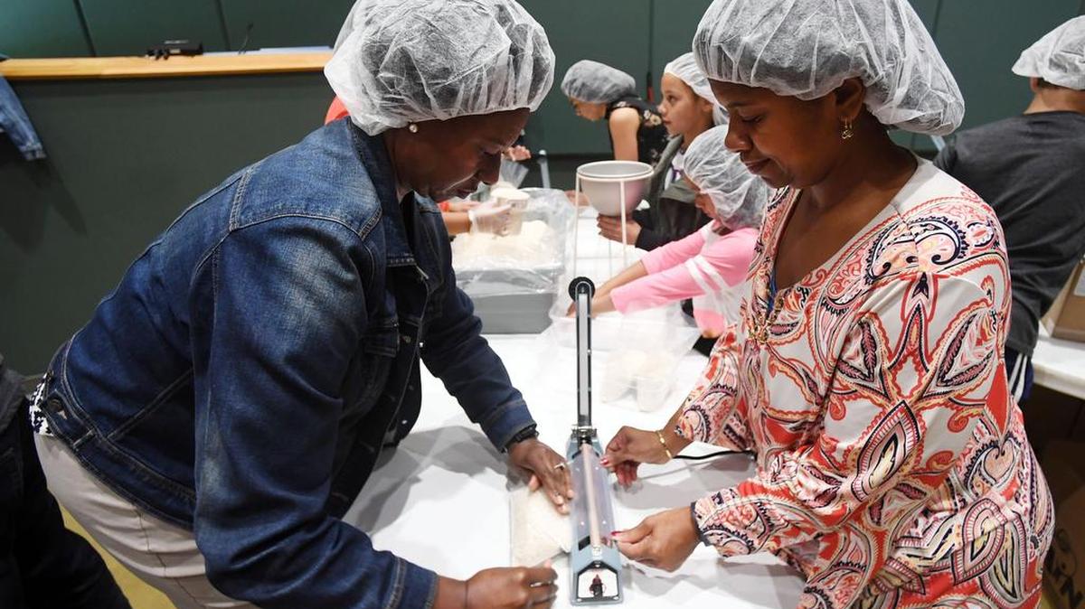 Georjanne Williams, left, and Leslie Laing seal bags of rice during the CityServe food packing project on Sunday at Calvary Church in Boalsburg.
