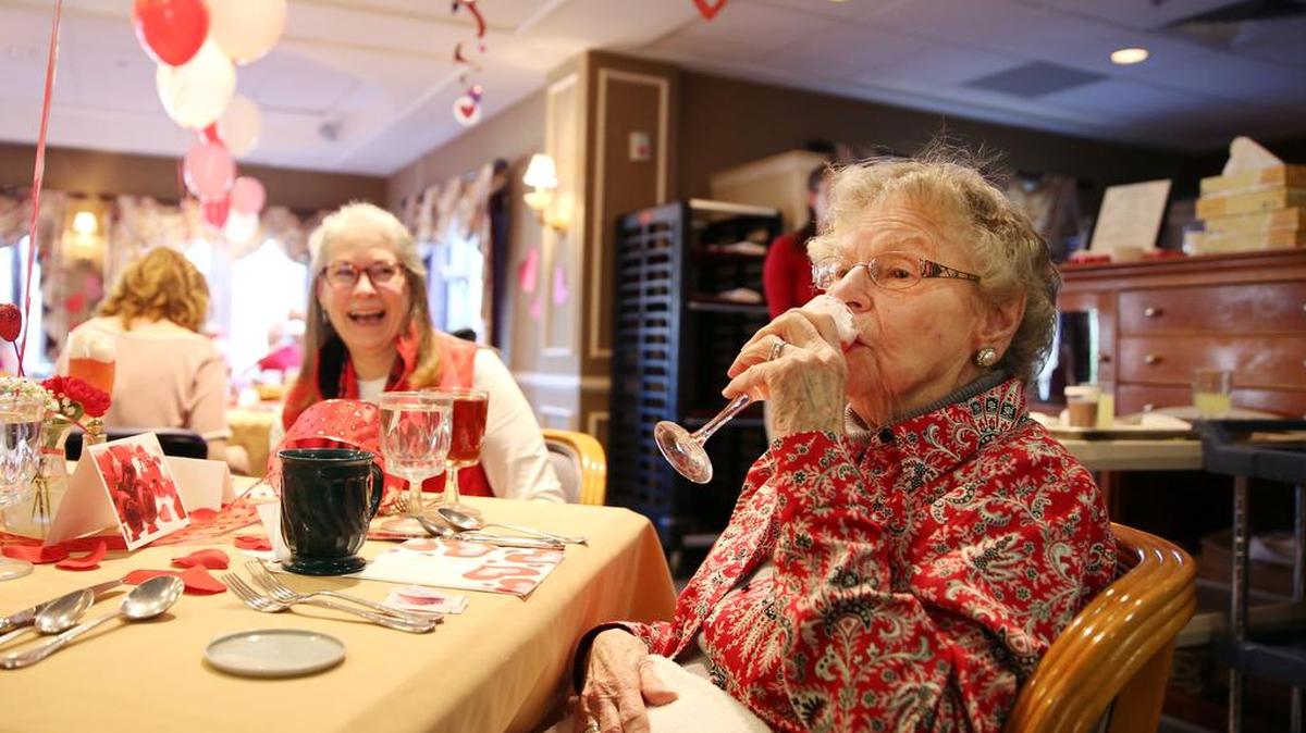 Ramona Hughes sips a glass of “love potion” during Tuesday’s Valentine’s Day luncheon at the Atrium at the Village at Penn State.