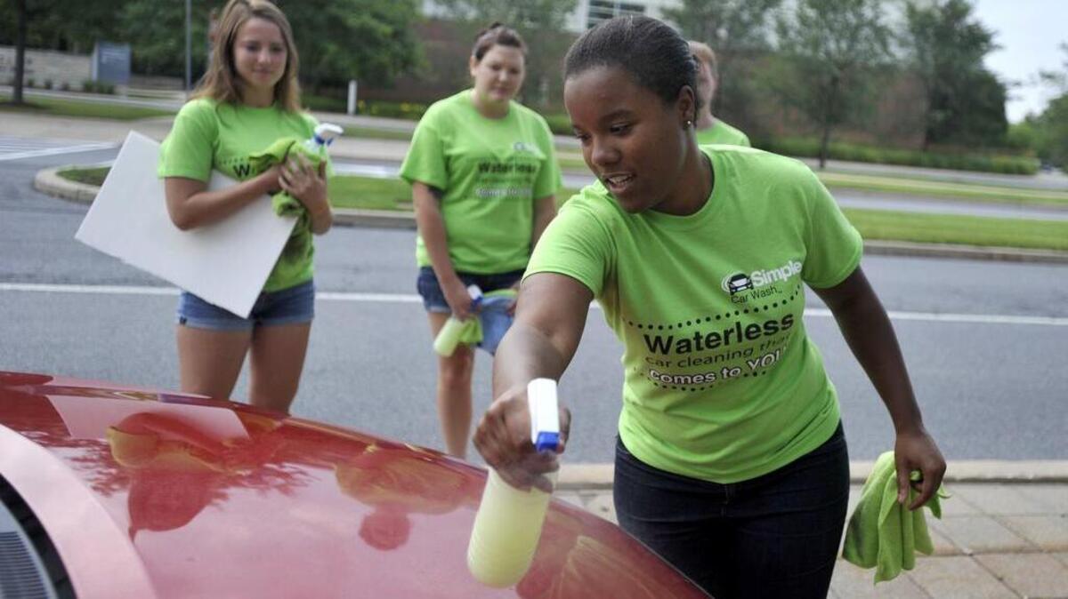 Taylor Mitcham, founder of Simple Car Wash, sprays a waterless car wash solution during a demonstration at an event at Innovation Park on July 31. Student entrepreneurs, such as Mitcham, will soon have a space in downtown State College to interact and spur economic development.