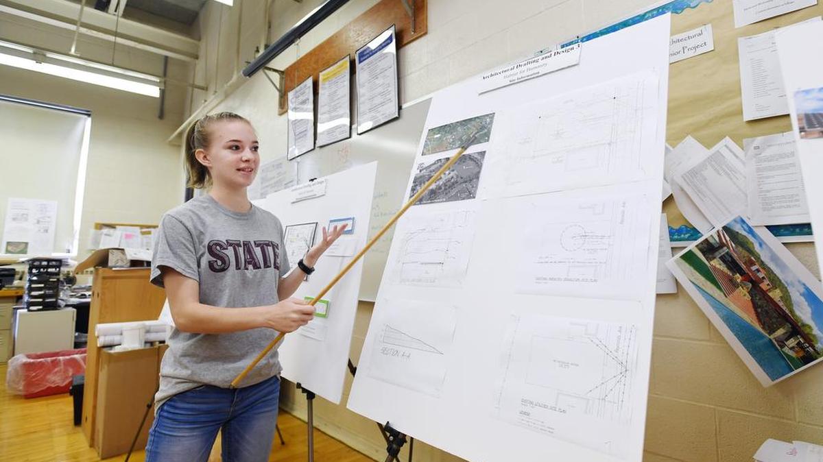 State College Area High School junior Kira Dolan goes over the plans Tuesday for the Habitat for Humanity house her class is designing in Bellefonte.