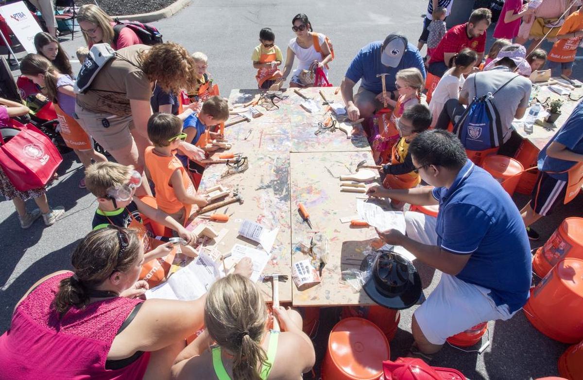 Families build wooden toolboxes, helicopters and more at the Home Depot booth on Saturday at the Patton Township Children’s Fair.