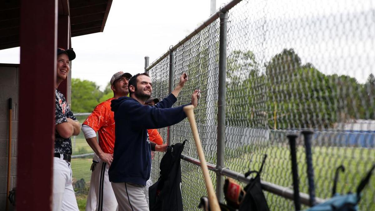 Tigers teammates look up at a foul ball during a game May 21 at the Teener league complex.