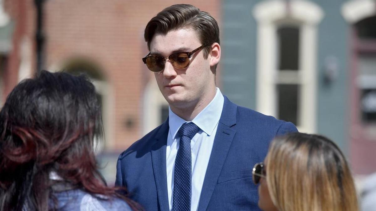 Beta Theta Pi brother Joseph Ems talks with family outside the Centre County Courthouse on Sept. 1, 2017.