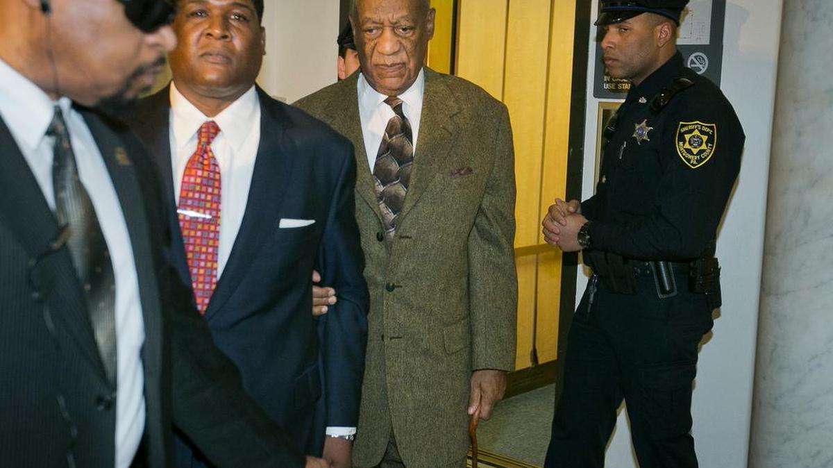 Bill Cosby, second from right, leaves after a court appearance Tuesday in Norristown. Cosby was arrested and charged with drugging and sexually assaulting a woman at his home in January 2004.