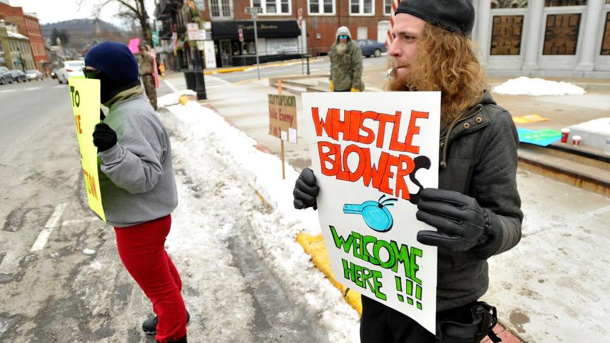 John Adams blows a whistle during a protest in front of the Centre County courthouse in Bellefonte on Wednesday, Jan. 14, 2015.