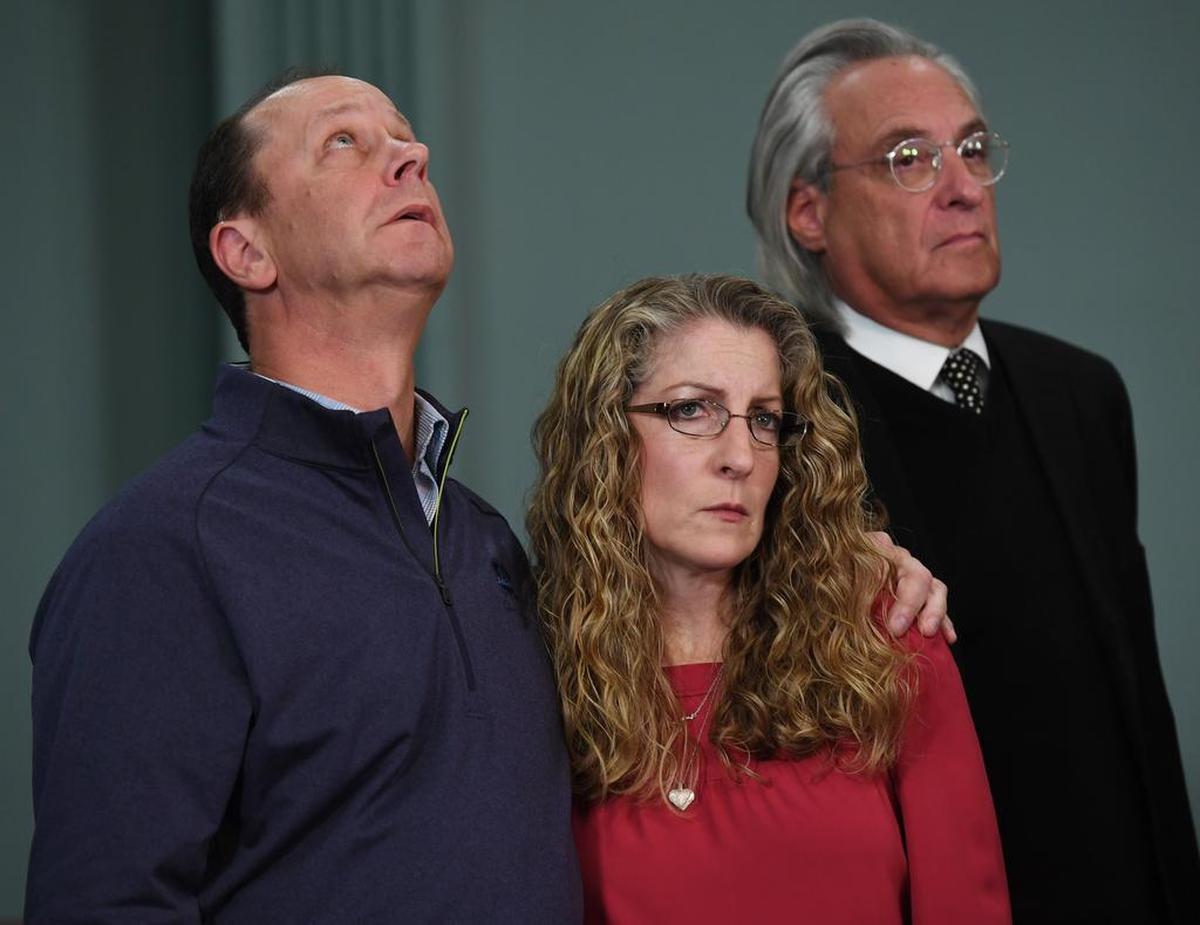 Jim Piazza looks up as Evelyn Piazza looks forward as they listen to former Centre County District Attorney Stacey Parks Miller speak during a news conference on Monday, Nov. 13, 2017, at the Centre County Courthouse Annex.