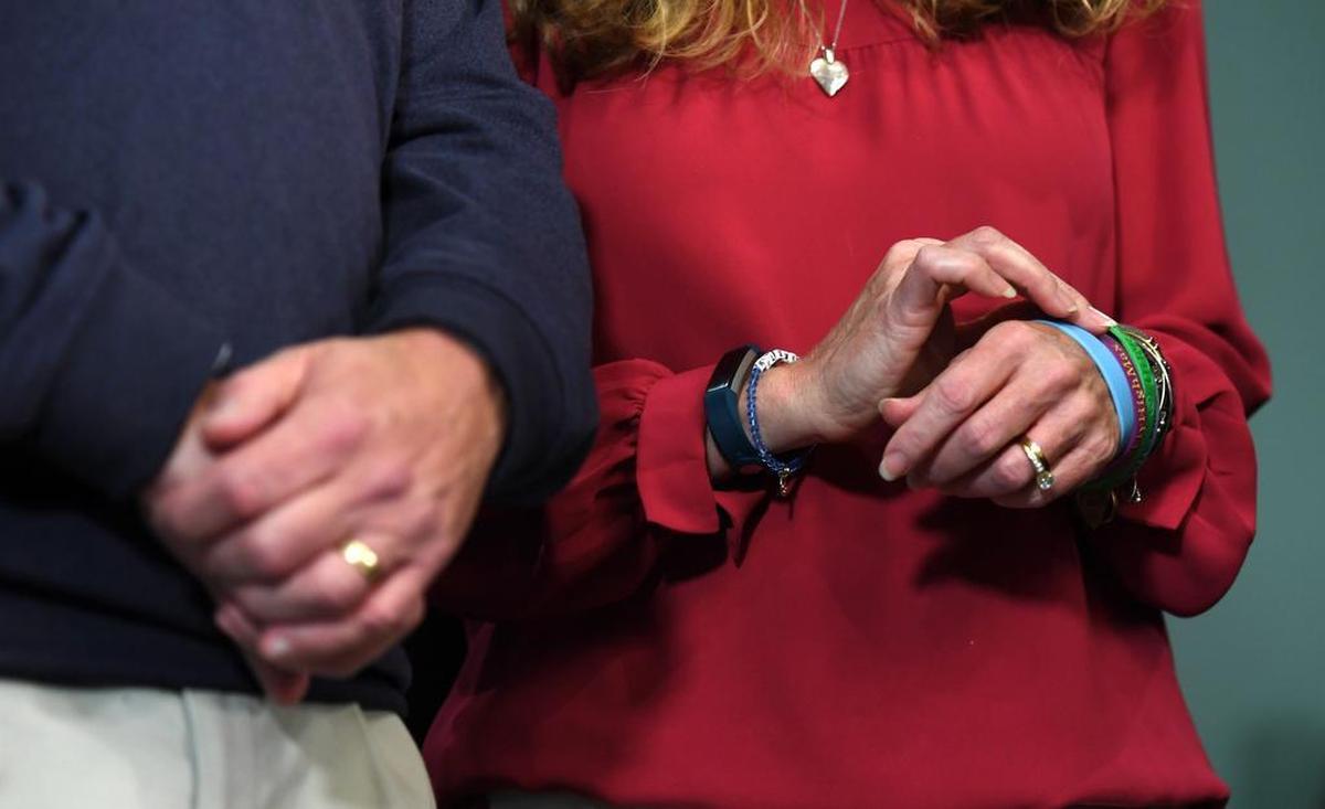 Evelyn Piazza touches the bracelets she wears in memory of her son, Timothy Piazza, as she and her husband Jim Piazza listen on Nov. 13, 2017 as charges were read against members of Penn State’s Beta Theta Pi fraternity.