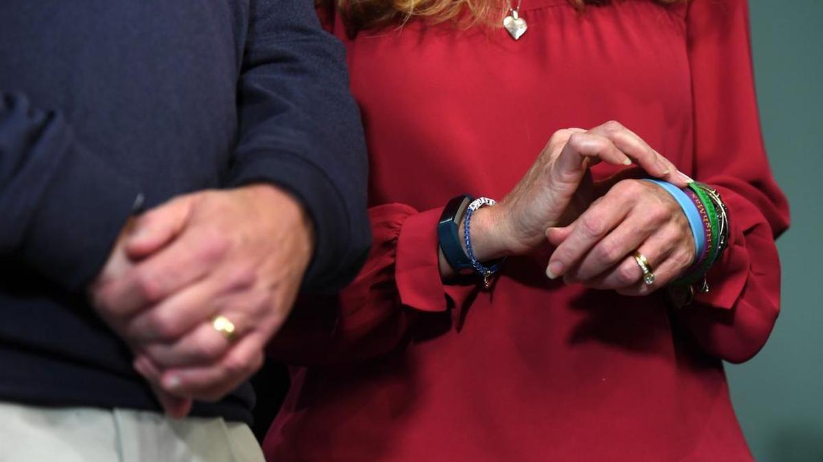 Evelyn Piazza touches the bracelets she wears in memory of her son, Timothy Piazza, as she and her husband Jim Piazza listen as new charges are read against members of Penn State’s Beta Theta Pi fraternity in November after the recovery of basement surveillance footage from inside the frat house of the night Timothy Piazza sustained fatal injuries.