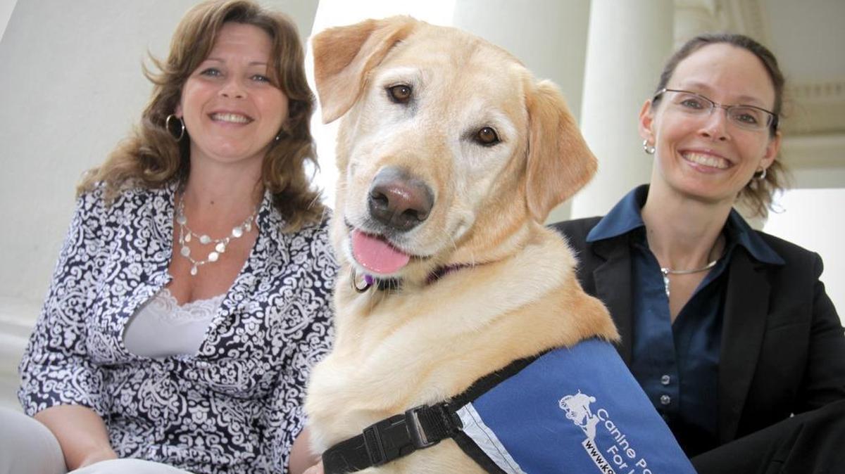 Faith Berger, left, victim witness coordinator, and Mary Pinkerton, victim advocate, pose with Princess, Centre County's victims' advocate dog, outside of the courthouse in Bellefonte on Tuesday, June 15, 2010.