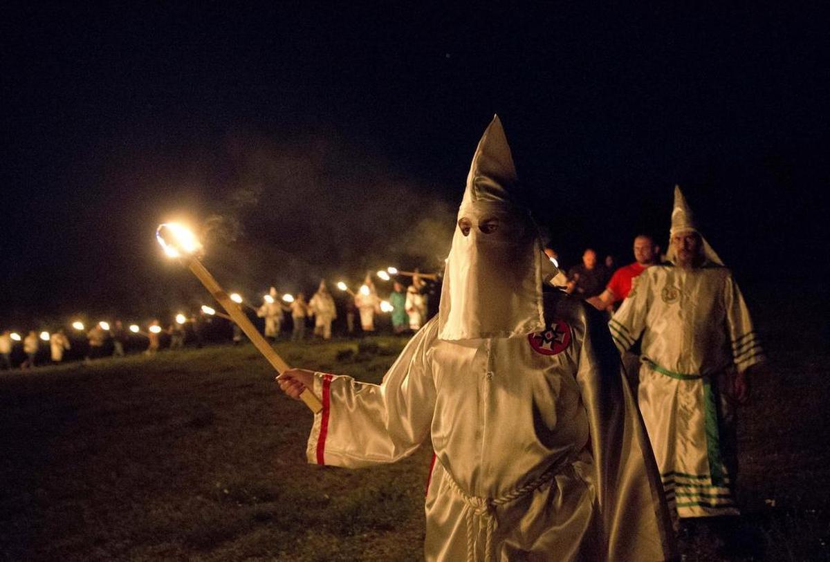 Members of the Ku Klux Klan participate in cross burnings after a “white pride” rally in rural Paulding County near Cedar Town, Ga. Born in the ashes of the smoldering South after the Civil War, the KKK died and was reborn before losing the fight against civil rights in the 1960s.