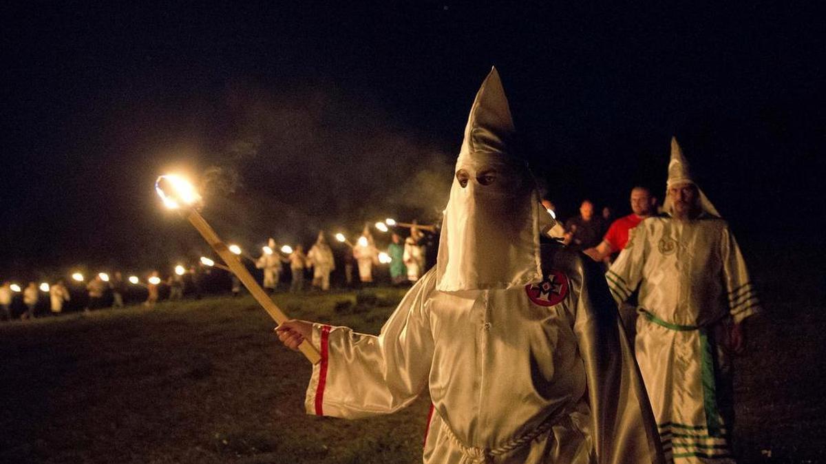 Members of the Ku Klux Klan participate in cross burnings after a “white pride” rally in rural Paulding County near Cedar Town, Ga. Born in the ashes of the smoldering South after the Civil War, the KKK died and was reborn before losing the fight against civil rights in the 1960s.