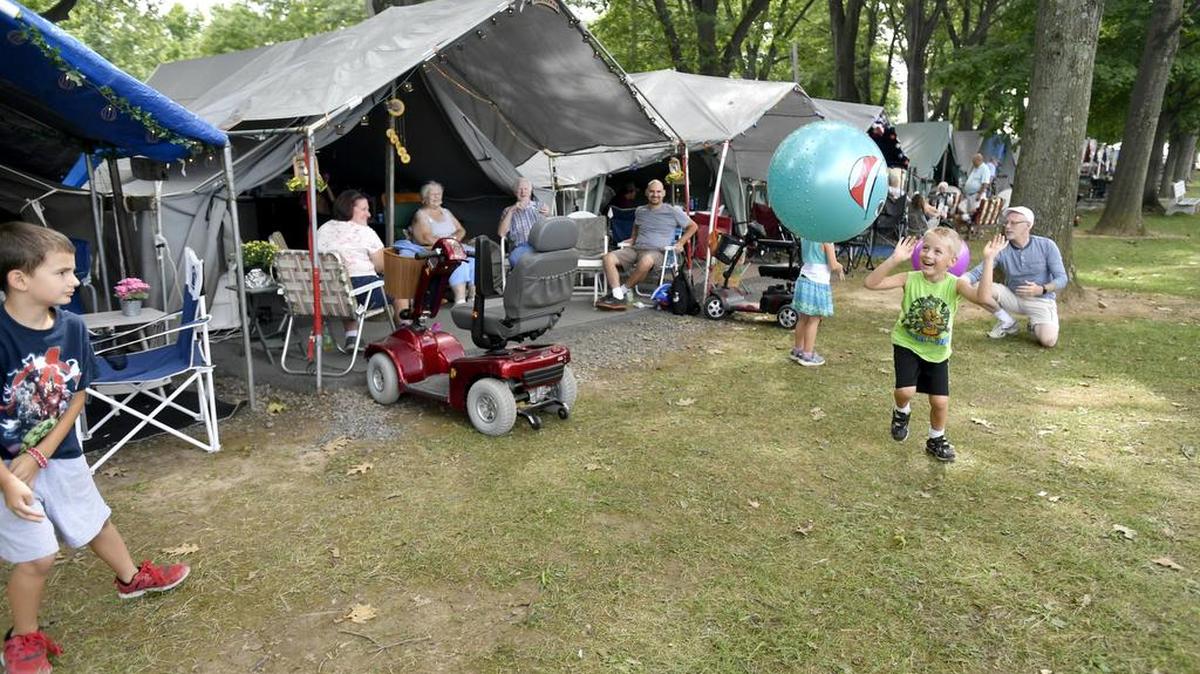 Josiah Pimental, 5, plays with his siblings outside of the families tent during the Centre County Grange Encampment and Fair on Saturday.