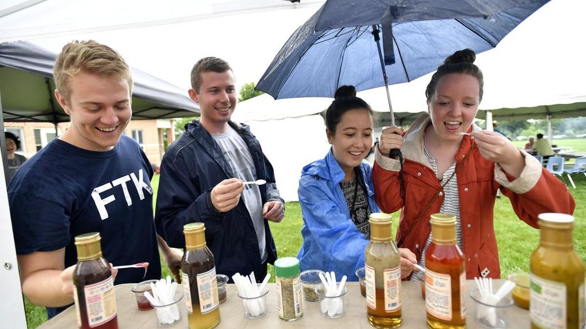 From left, Cody Stubbs, Grant Caspero, Catherine Corbett, and Emily Schoettler taste kitchen sauces from the Village Eatinghouse. The Happy Valley Culinary Week Food Festival was held Thursday at South Hills School of Business and Technology.