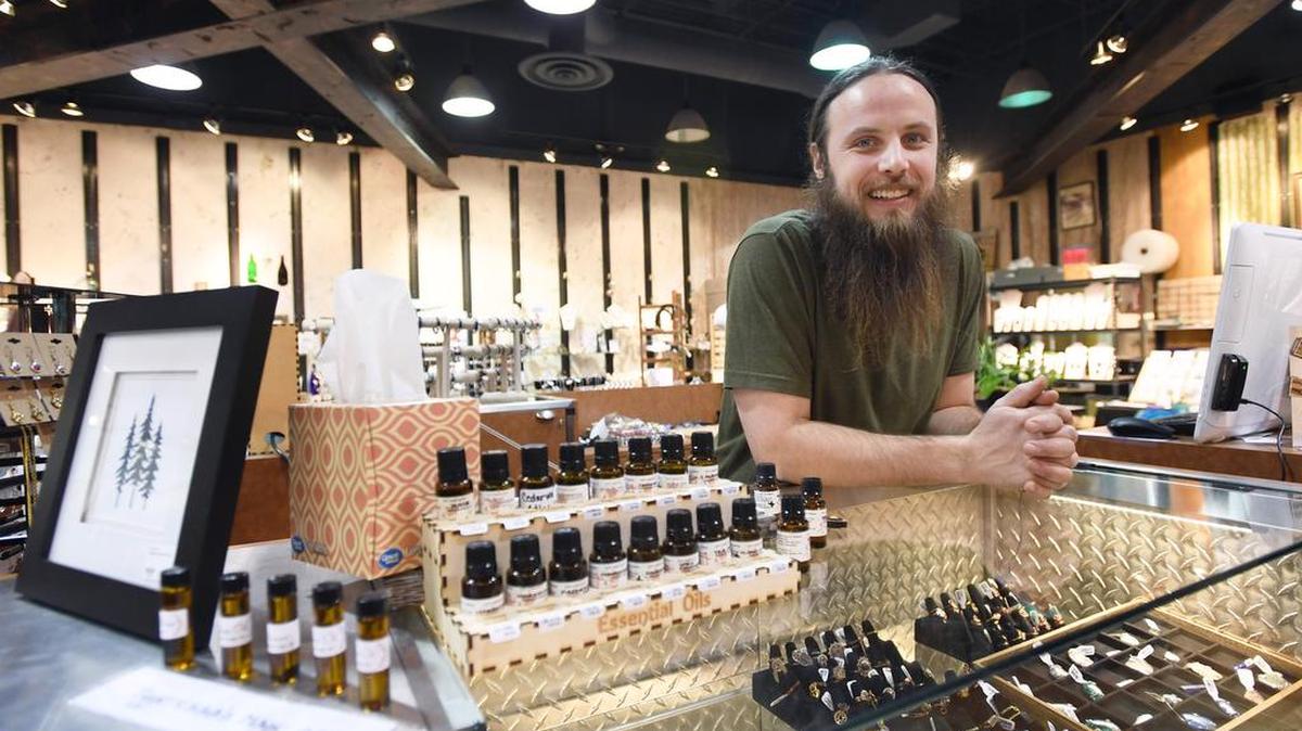 K.C. Peck, owner of Emporium Market, poses for a portrait Tuesday inside of the store at the Nittany Mall.