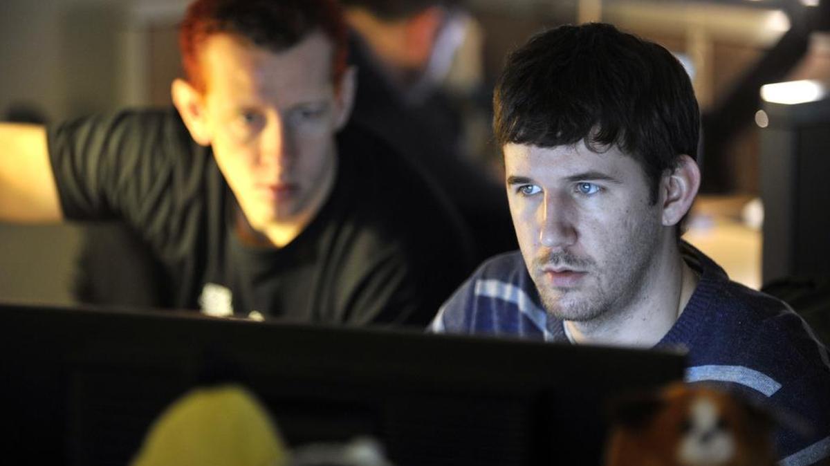 Clarence Miller, left, and Micheal Hartsock troubleshoot code for a website at Schoolwires. Schoolwires, a State College-based company, utilized Innovation Park services, including Ben Franklin Technology Partners, which provides funding and business support to technology-based startups.