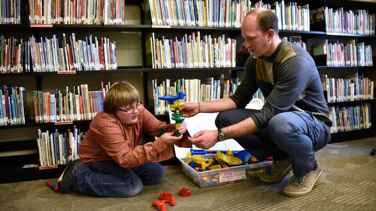 Librarian Dustin Brackbill works with a student on a project during Mount Nittany Elementary’s Makerspace, which the the school hosts every week.