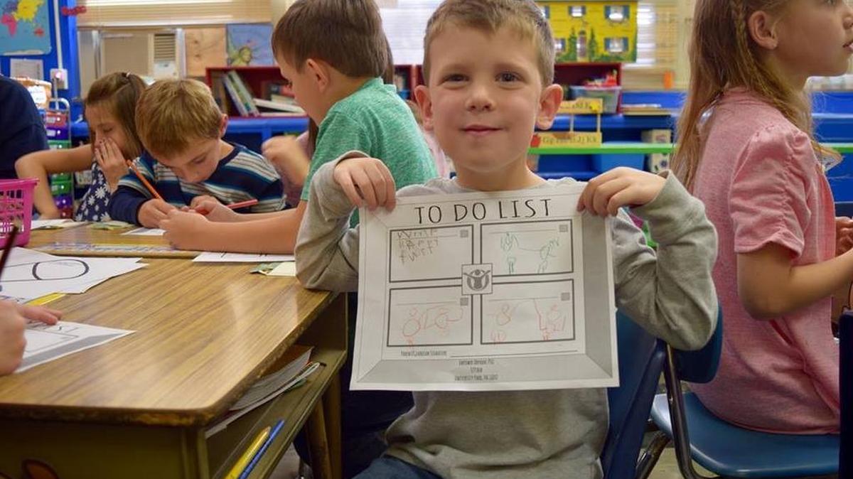 St. John Catholic school kindergarten student Cayden Stover shows off his work.