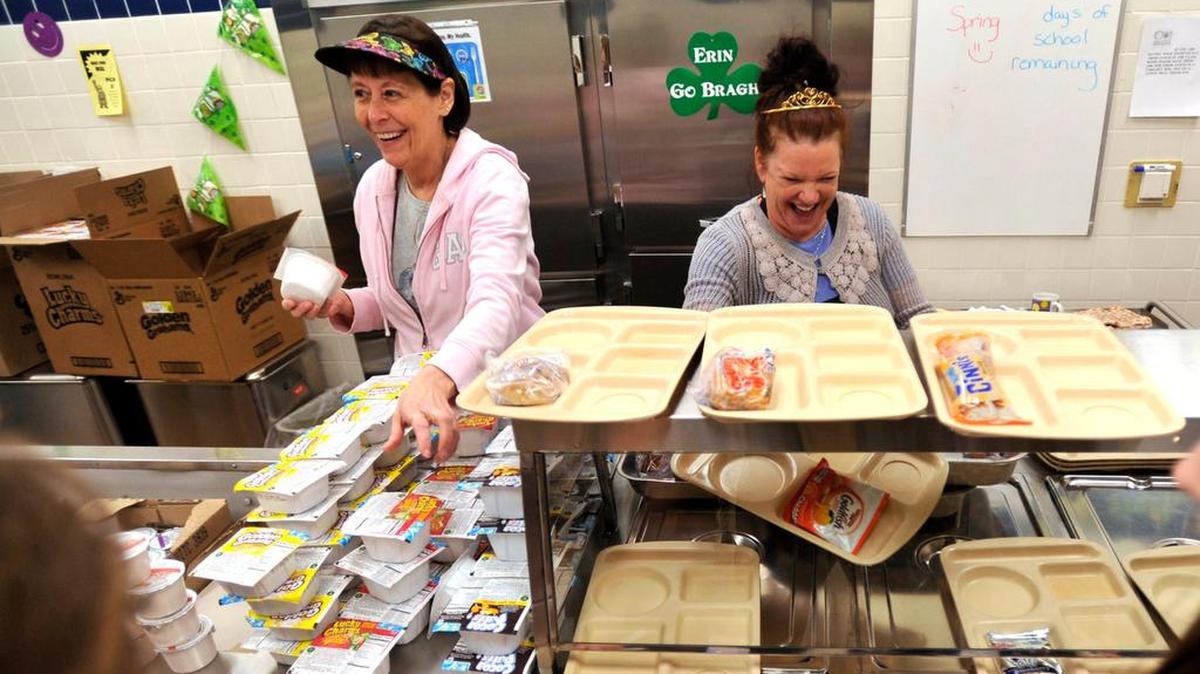 Workers Diane Josefik, left, and Wendy Grannis, right, joke around with students as they orders at Philipsburg-Osceola Elementary School.