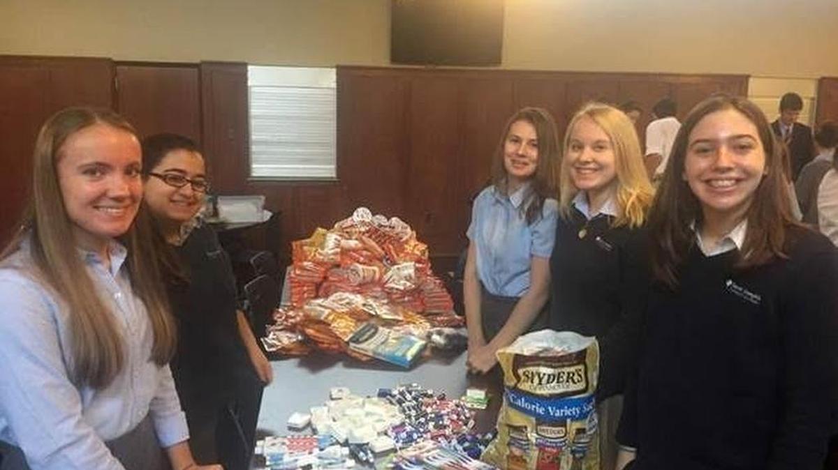 St. Joesph’s Catholic Academy students Jordan Dawson, Amanda Mohamed, Veronica Emigh, Anna Henderson, and Shannon Saclyn help collect goods to sent to troops overseas. It was part of a schoolwide service project during the holidays.