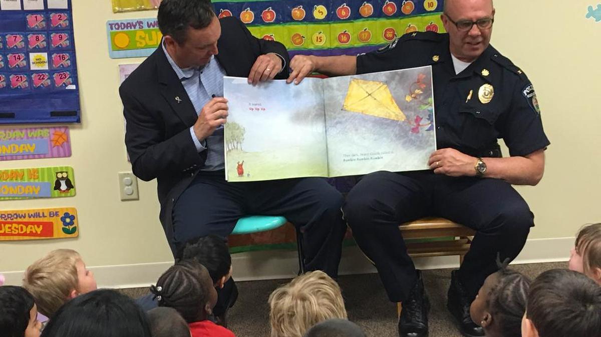 State Sen. Jake Corman, left, and State College police Chief Tom King read “Kite Day” to pre-K students at St. Paul’s Christian Preschool and Childcare in downtown State College. Corman met with law enforcement and educators at the school on Sunday to discuss the infusion of state funds and the school’s new pre-K classroom.