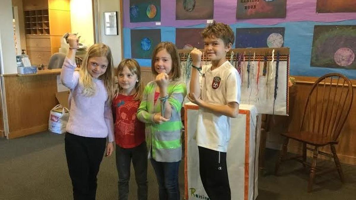 Audrey Hertert, Clarisse LaJeunesse, Maddie Gibson and Leo Witzke show off knitted bracelets they made for a class project. They’re part of Sunna deForest’s combined second- and third-grade class at State College Friends School that participated in a project to knit bracelets and sell them for $5 to help fund additions to the school’s playground.