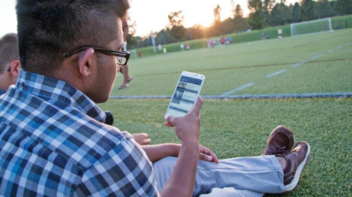 Dilanka Dharmasena, one of the founders of the app First Pick, checks the app at the West Soccer Fields on Penn State’s campus. The app streamlines the pick-up sports experience, and recently launched on the App Store and Google Play.