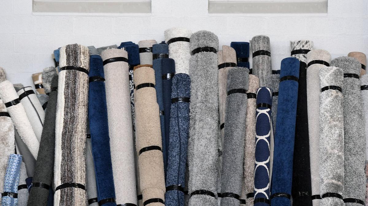 Rugs are lined up in preparation for the annual Trash to Treasure sale in May 2018 at Beaver Stadium. Penn State research examines how exchanging items such as furniture keeps it out of landfills and incinerators.