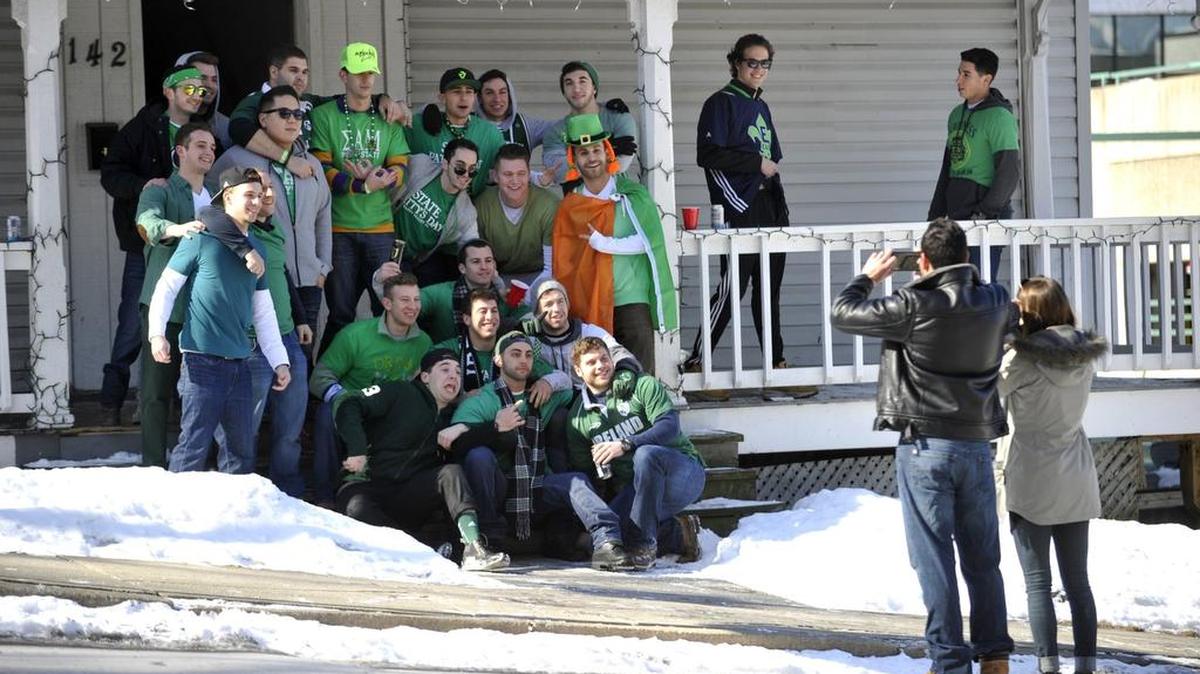 A group of fraternity brothers pose for a picture in front of their house along McAllister Street as they kick off their State Patty’s Day celebration. Student alcohol use was a topic of discussion at a board of trustees committee meeting on Thursday.