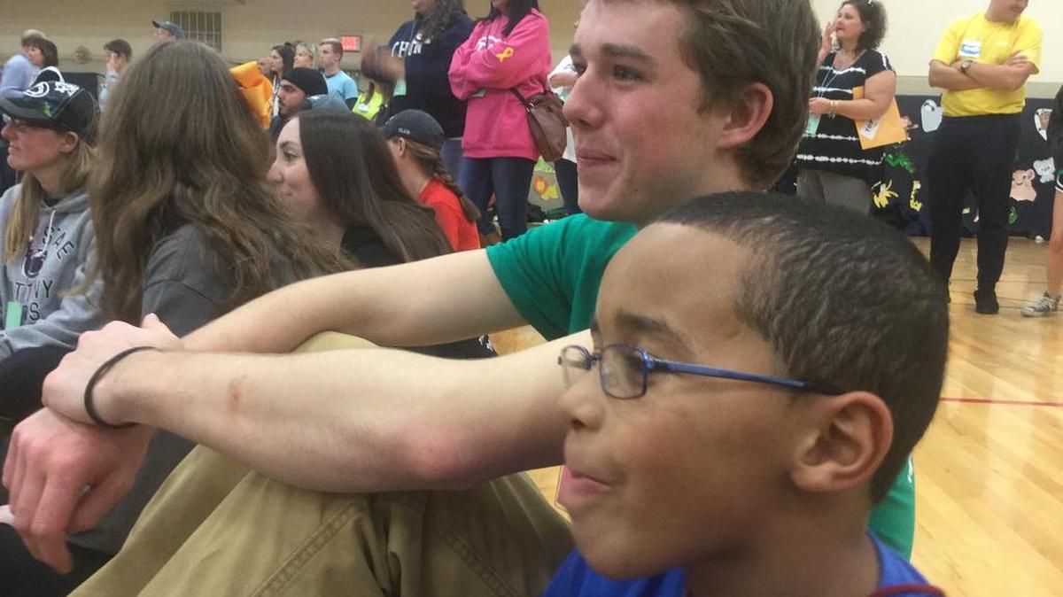 Penn State Thon volunteer Steve Sandford sits with Thon child Elliot Ross at the 2016 Family Carnival on Sunday.