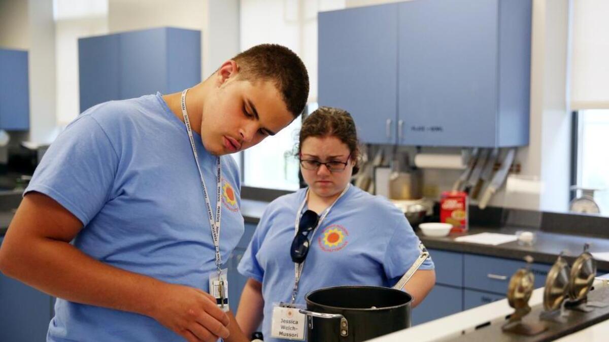 Emmitt Lee listens to hear if the water is boiling while cooking macaroni and cheese during the Summer Academy for Students Who are Blind or Visually Impaired Tuesday, July 25, 2017 at Penn State.